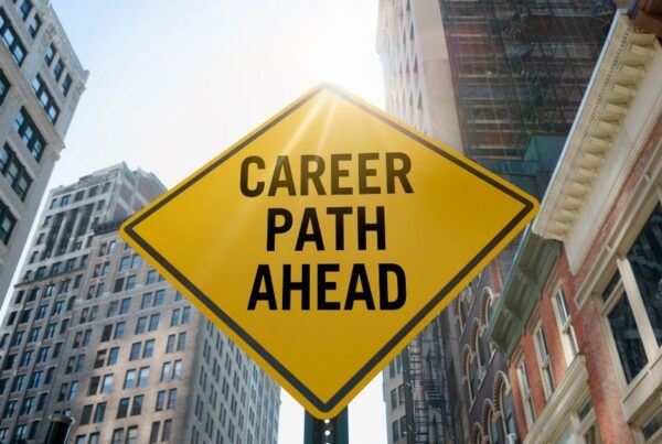 Road sign saying 'Career Path Ahead' with builidngs in background